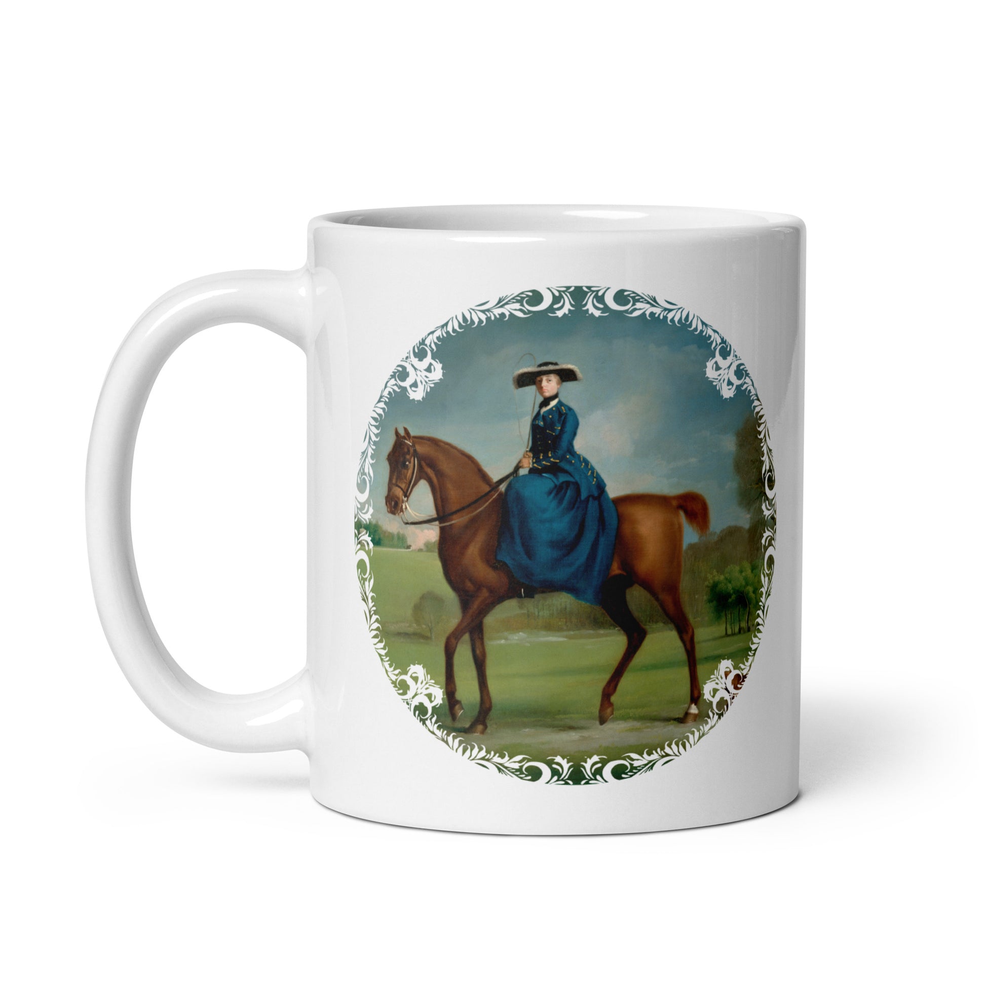 A white ceramic mug with an illustration of a woman in riding attire mounted on a horse, with a decorative border around the illustration.